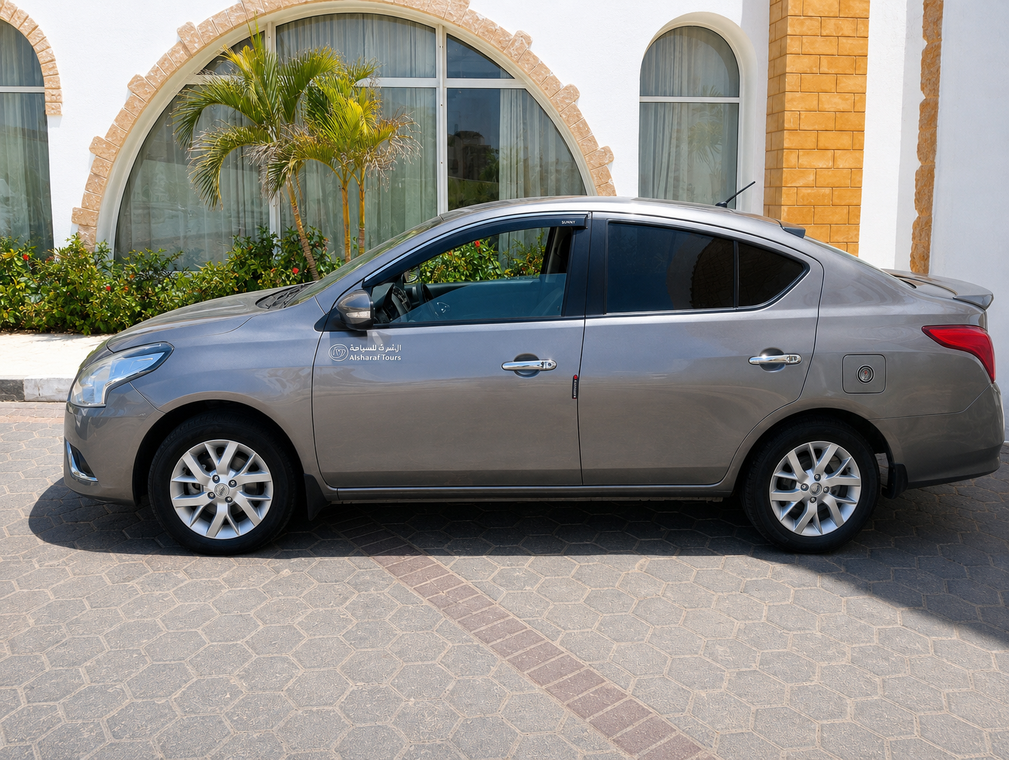 Our Nissan Sunny sedan parked outside a South Sinai resort, ready for guest transfers